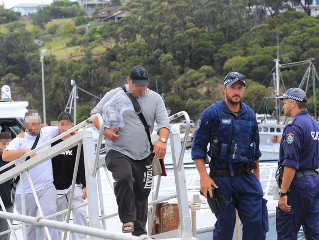 Passengers are escorted by police off the Carnival Legend.