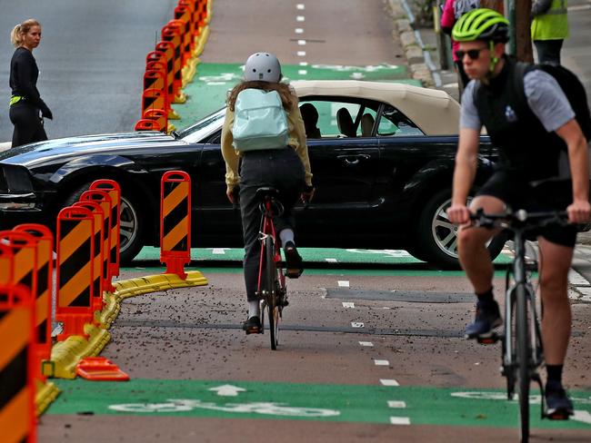 The City of Sydney has turned a bus lane into a bike lane on Fitzroy St in Surry Hills in a bid to get more commuters on bikes and off public transport. A car pulls out of a side street and across the bike lane. Picture: Toby Zerna