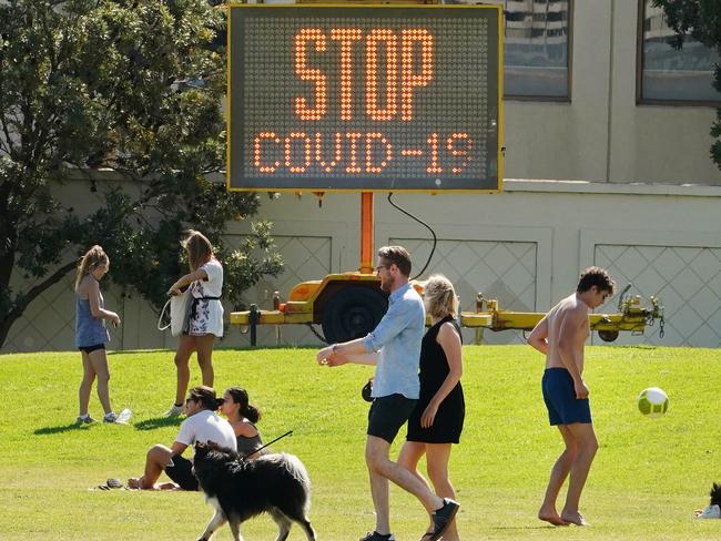 People are seen at St Kilda Beach in Melbourne on Saturday, March 28. Picture: AAP