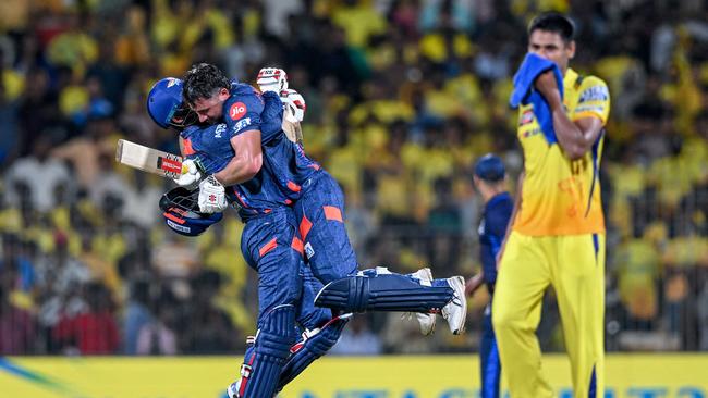 Lucknow Super Giants' Marcus Stoinis (C) celebrates with Deepak Hooda (L).