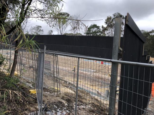 A holding pond, with piping and a portable generator, on the southern edge of the construction site at Allambie Heights on Friday. Picture: Jim O’Rourke