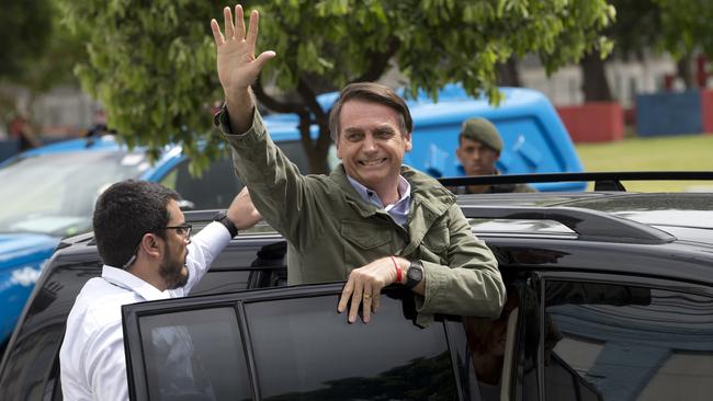 Jair Bolsonaro waves after voting in the presidential election. Picture: AP.