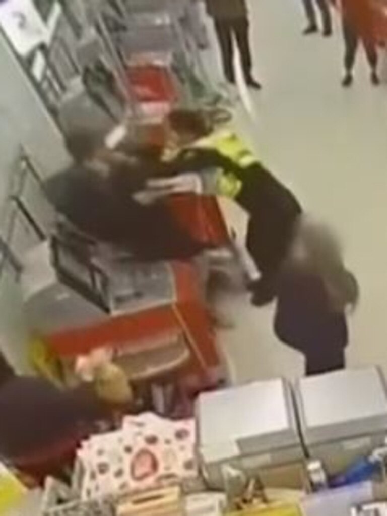 He then pushes the customer into the bagging area and pins him to the wall. Picture: 7 NEWS