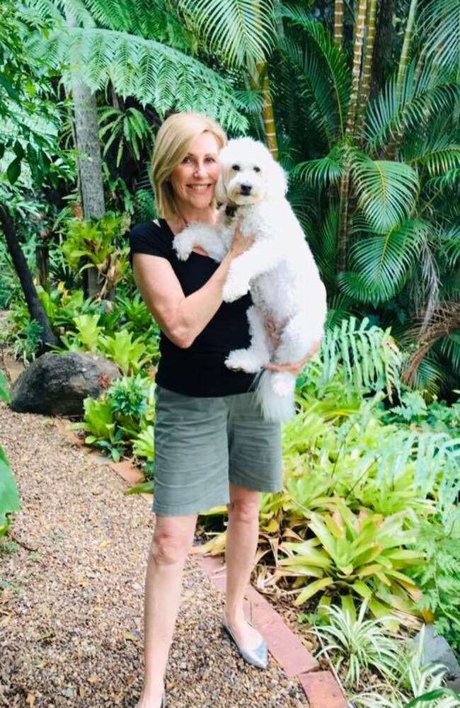 Kay McGrath in her backyard with her dog.