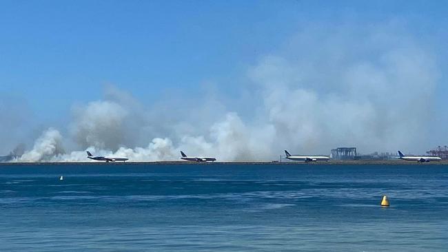 A﻿ grass fire has broken out at Sydney Airport, reportedly after a malfunction with an aircraft's engine on takeoff. Picture: 9News