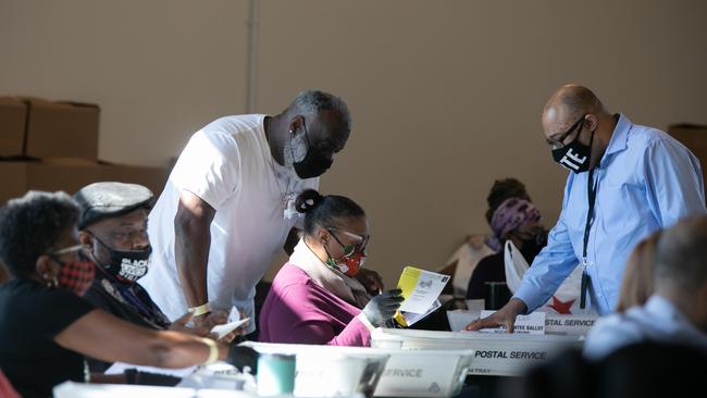 Election workers count ballots at State Farm Arena in Atlanta, Georgia last night.