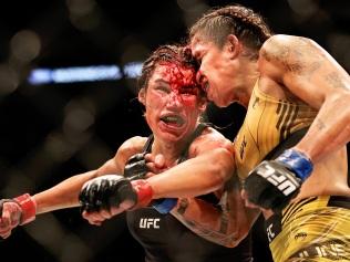 DALLAS, TEXAS - JULY 30: Amanda Nunes of Brazil exchanges strikes with Julianna Pena in their bantamweight title bout during UFC 277 at American Airlines Center on July 30, 2022 in Dallas, Texas. (Photo by Carmen Mandato/Getty Images)