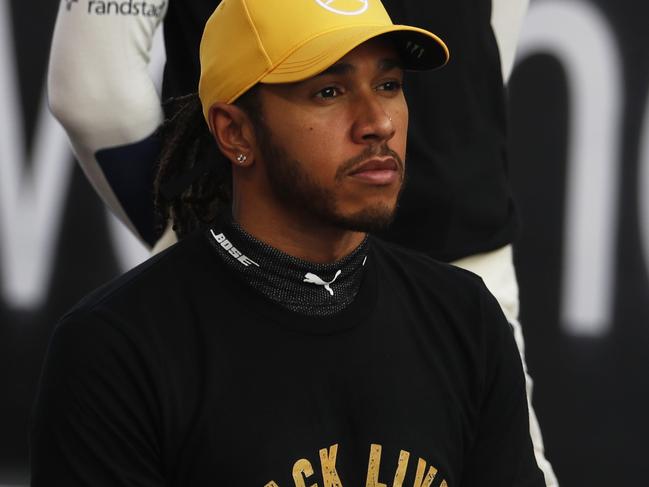 ABU DHABI, UNITED ARAB EMIRATES - DECEMBER 13: Lewis Hamilton of Great Britain and Mercedes GP kneels in support of ending racism prior to the F1 Grand Prix of Abu Dhabi at Yas Marina Circuit on December 13, 2020 in Abu Dhabi, United Arab Emirates. (Photo by Hamad I Mohammed - Pool/Getty Images)