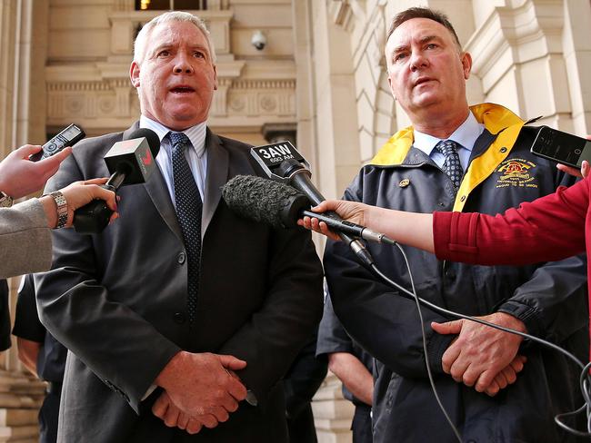 Ambulance Employees Australia Victoria secretary Steve McGhie speaks outside State Parliament alongside fire union boss Peter Marshall. Picture: Mark Stewart