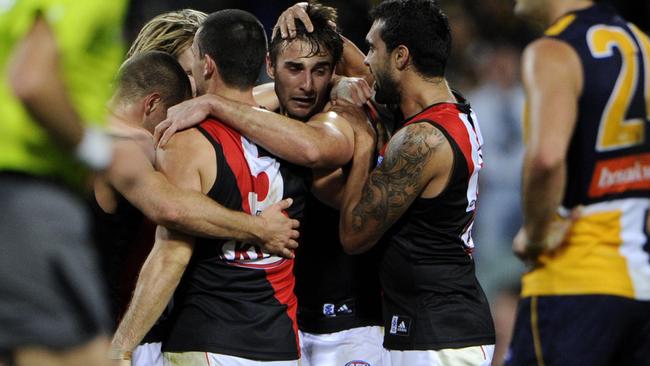 Essendon players embrace Jobe Watson after a tough night.