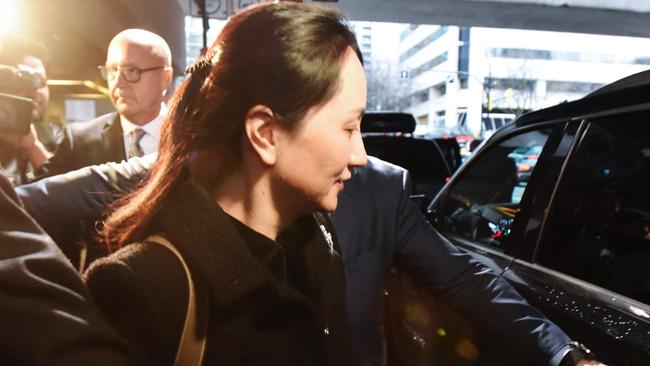 Meng Wanzhou leaves British Columbia Supreme Court with her security detail on the first day of her extradition hearing on Tuesday. Picture: AFP