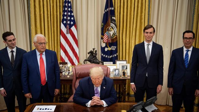 US Ambassador to Israel David Friedman (2nd L), Senior Advisor Jared Kushner (2nd R), and US Secretary of the Treasury Steven Mnuchin (R) listen as US President Donald Trump announces an agreement between the United Arab Emirates and Israel to normalise diplomatic ties on August 13.