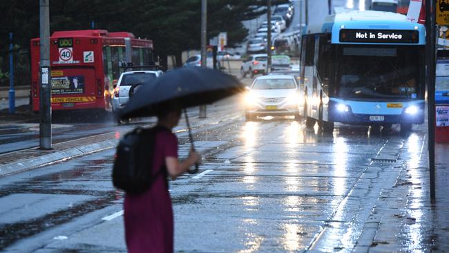 A pedestrian holds an umbrella during heavy rain in Coogee, Sydney on Friday.