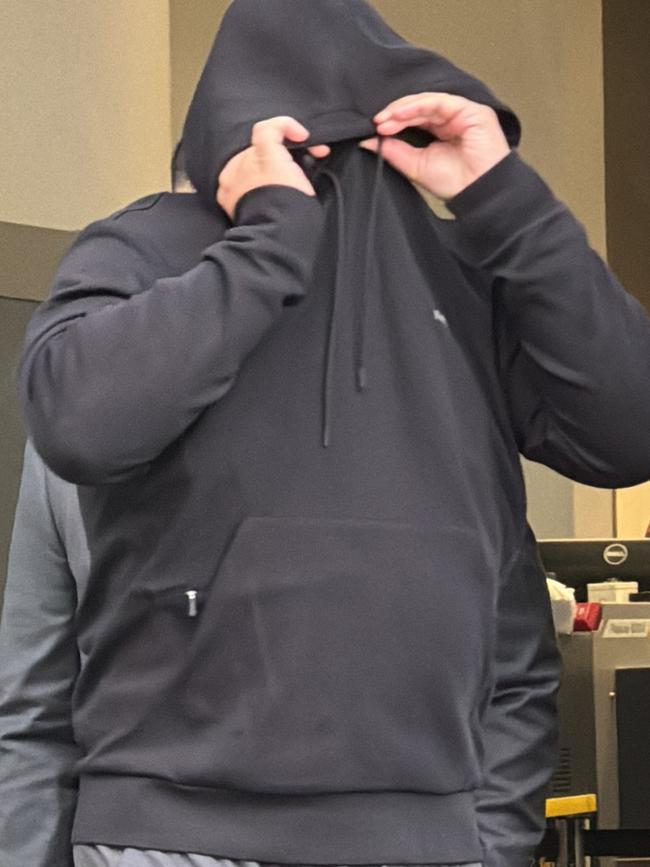 Panania resident Rabih Chamma, 38, covers his face outside Bankstown Local Court. Picture: Canterbury-Bankstown Express