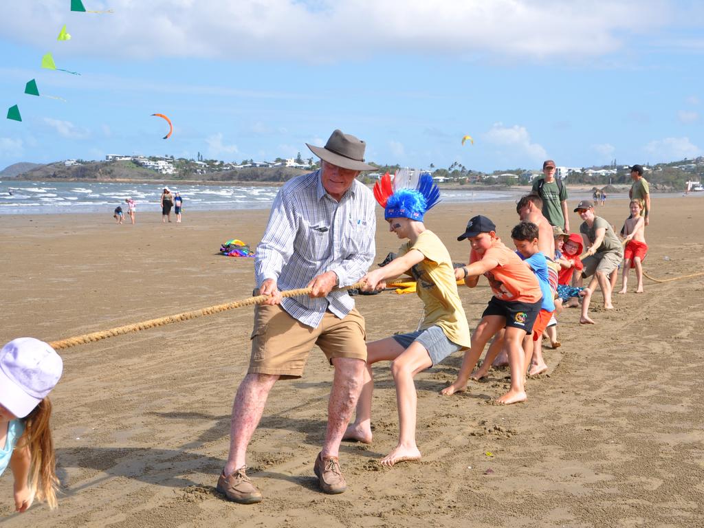 Cr Tom Wyatt jumping on the rope in the Tug-O-War on the beach