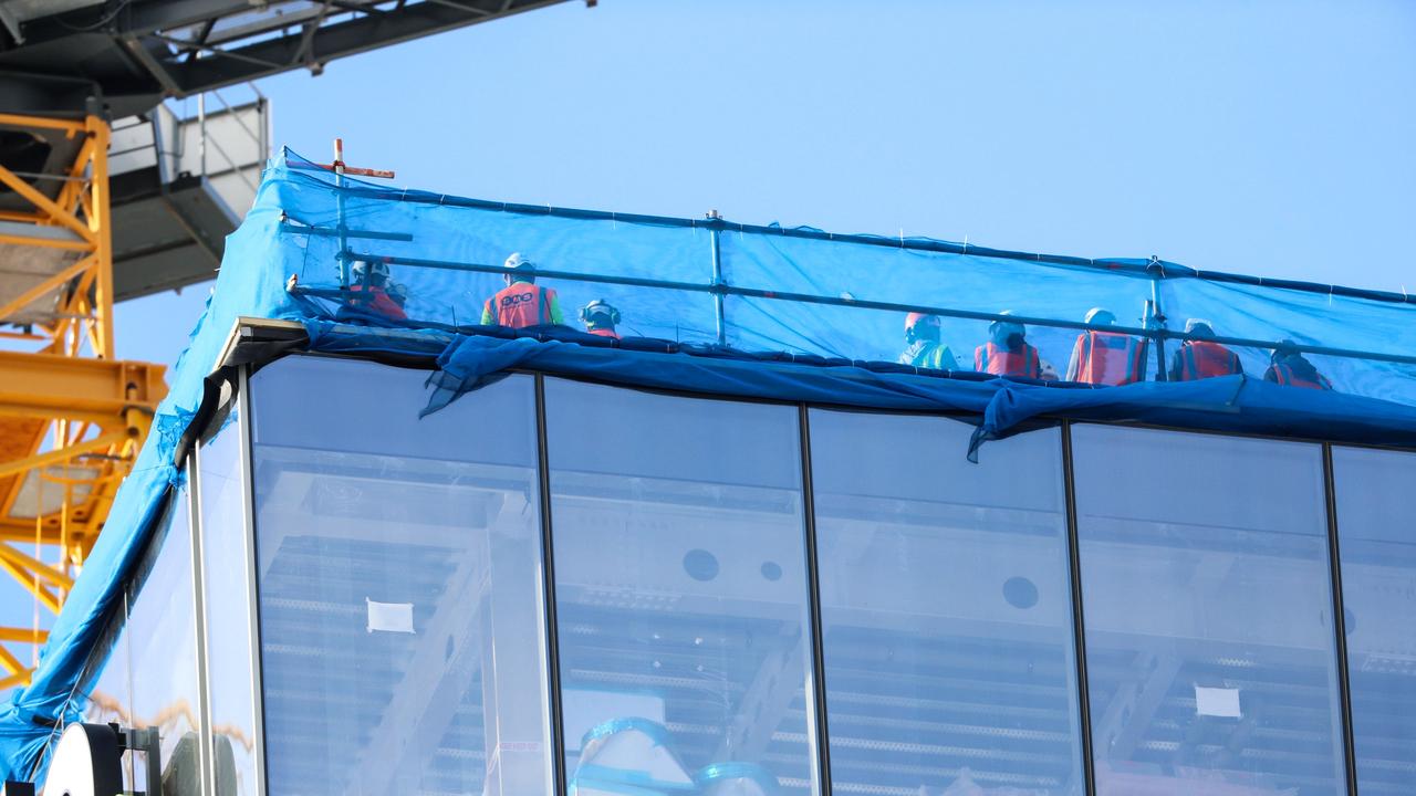 Construction workers shelter on the roof of a building in Downtown Auckland