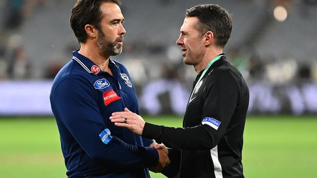 Old teammates Chris Scott and Craig McRae shake hands after Saturday’s entertaining clash. Picture: Getty Images