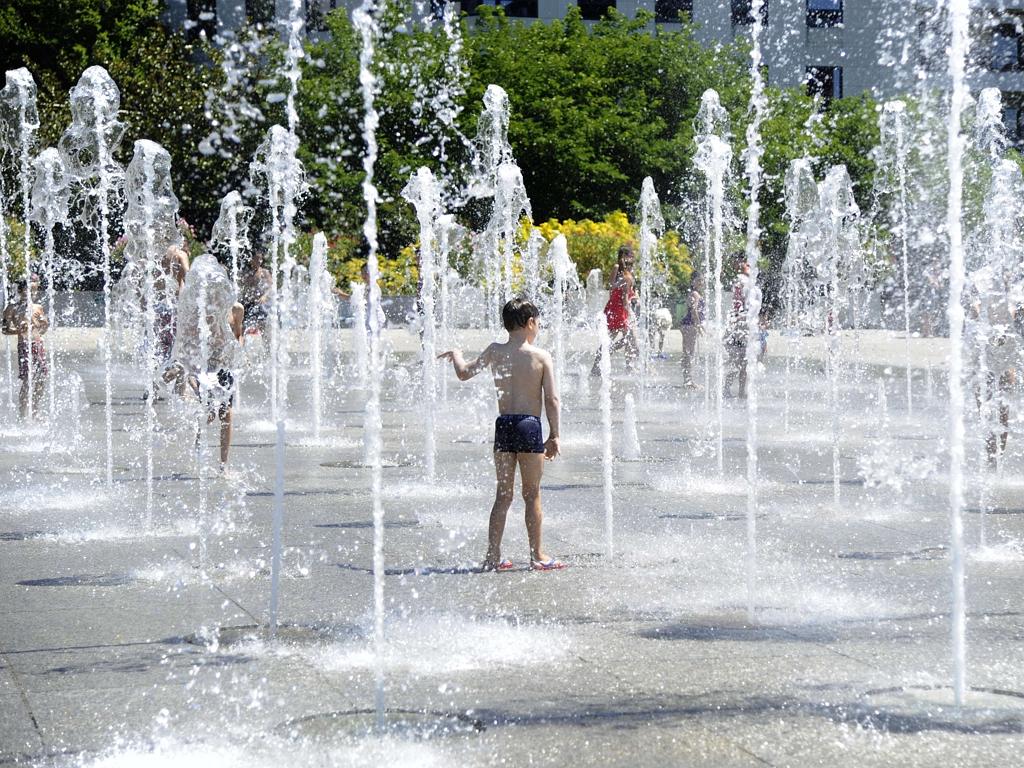 People cool-off in a fountain at the Andre Citroen park in Paris on June 30, 2015. Picture: AFP