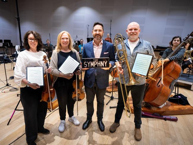 TasPlates CEO David McGrath (second from right in the front) with TSO musicians (from left to right) Anna Larsen Roach, Lucy Carrig-Jones and David Robins (with Aurora Henrich on double bass (right) and other musicians in the background. Picture Caleb Miller.