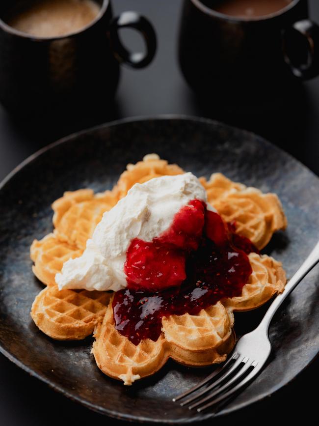 Waffle with strawberry jam and cream.