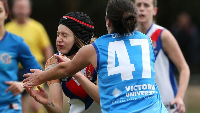 Tylah Spiteri of West Preston-Lakeside handpasses under pressure from Stefania Valerio of VU Western Spurs during NFLW footy: West Preston-Lakeside v VU Western Spurs on Saturday, August 11, 2018, in Epping, Victoria, Australia. Picture: Hamish Blair