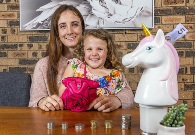 Natalie Haddock and daughter Audrey, with toys the four-year-old has bought with cash. Picture: Richard Walker