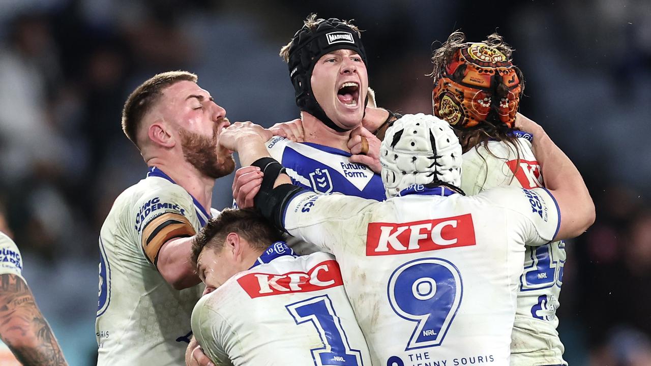 SYDNEY, AUSTRALIA - JUNE 28: Matt Burton of the Bulldogs celebrates with team mates after kicking a golden point field goal in extra time to win the round 17 NRL match between Canterbury Bulldogs and Cronulla Sharks at Accor Stadium on June 28, 2024, in Sydney, Australia. (Photo by Cameron Spencer/Getty Images)