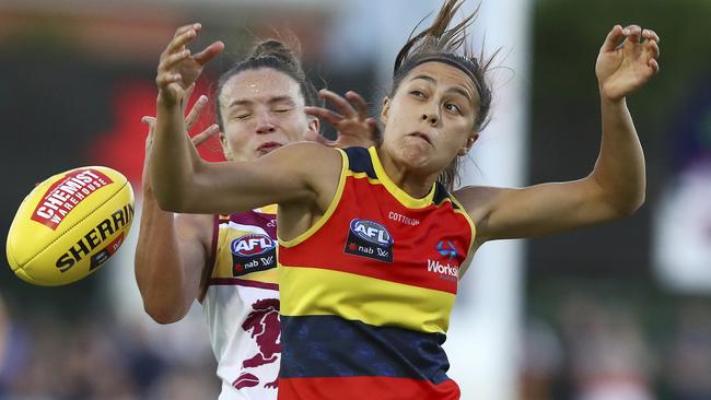 Adelaide’s Justine Mules is put under pressure by Brisbane’s Emily Bates. Picture: Sarah Reed