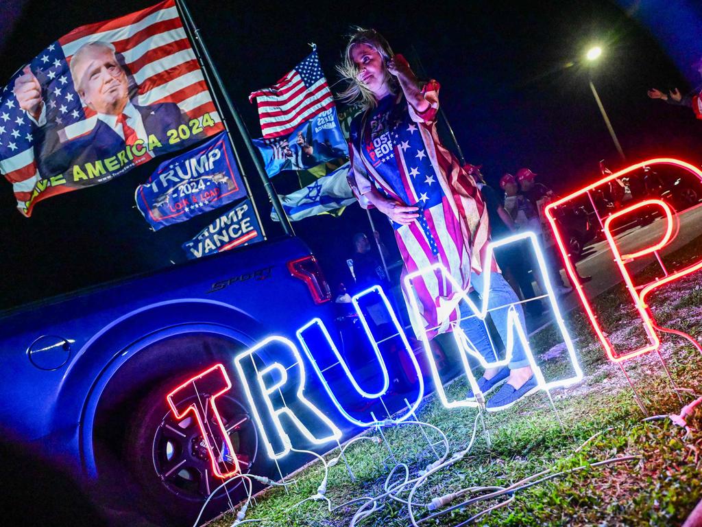 A woman wears a US flag jacket near Donald Trump’s residence at Mar-a-Lago in West Palm Beach, Florida. Picture: AFP