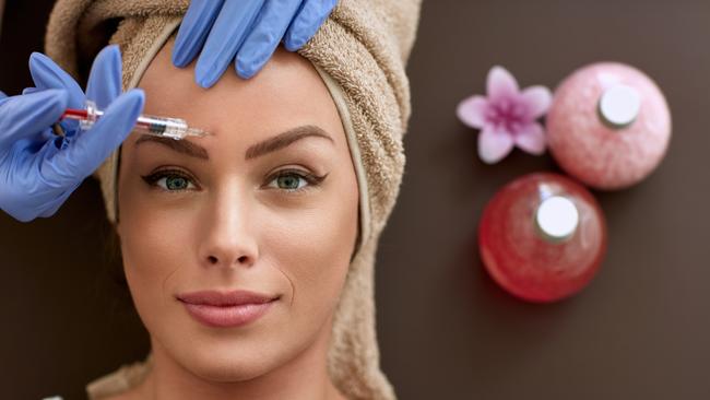 REAL DOLLS FEATURE stock image.Picture: iStock Beauty woman giving injections. as correction of wrinkles, cosmetic treatments