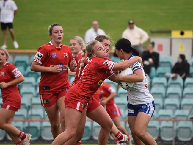 Charlotte Eather is hit hard in a tackle by Mia-Rose Walsh. Picture: Sean Teuma/NewsLocal