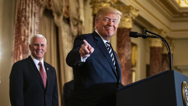 Donald Trump and Vice-President Mike Pence at the State Department yesterday. Picture: MEGA