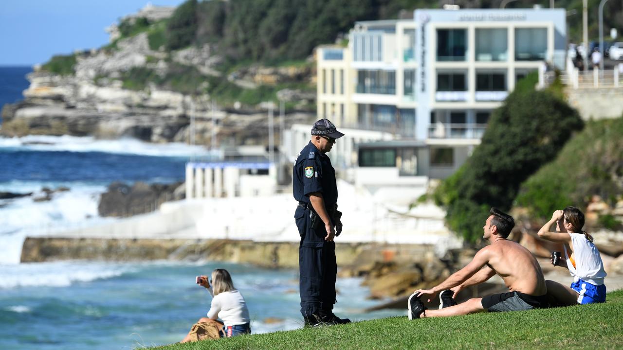 NSW Police ask people to move on while patrolling during the Easter long weekend at Bondi Beach. Picture: Joel Carrett/AAP