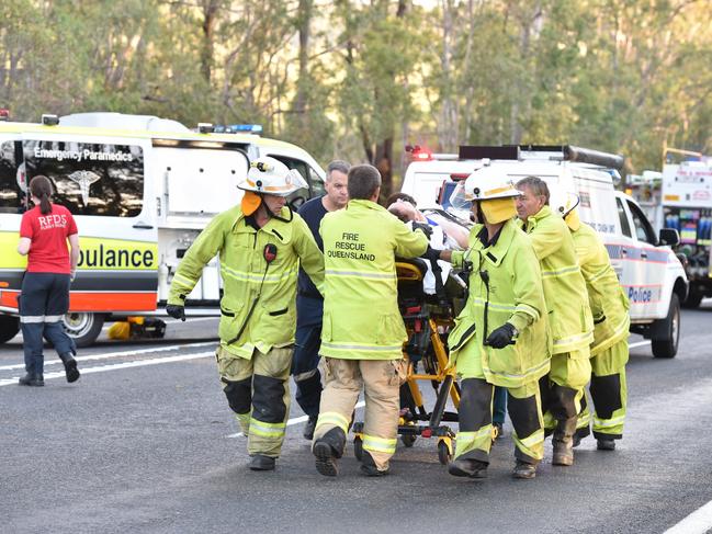 Patients are transported to the waiting helicopters at the scene of a double fatality on the Bruce Highway two kilometres north of Tiaro.