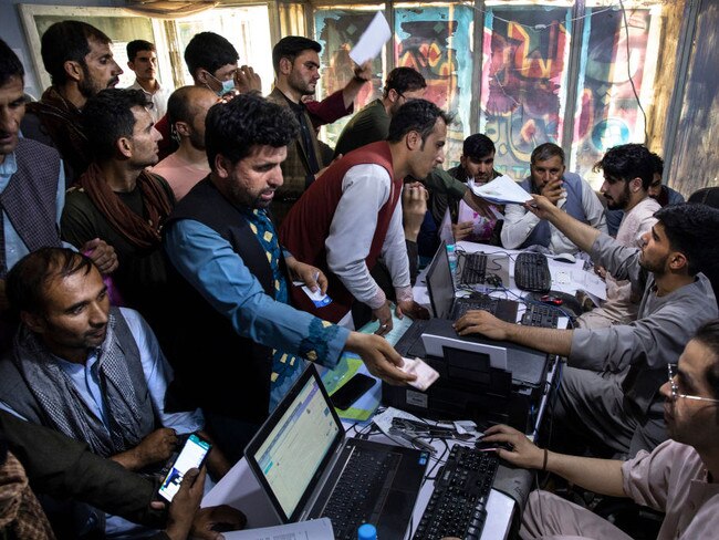 Afghan Special Immigrant Visa applicants crowd into the Herat Kabul internet cafe to apply for assistance.