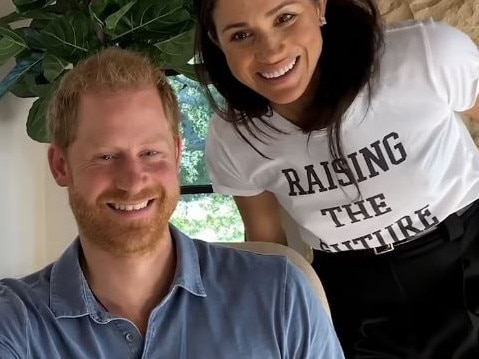 During the documentary, Meghan Markle is seen looking over Prince Harry's shoulder. Picture: Supplied