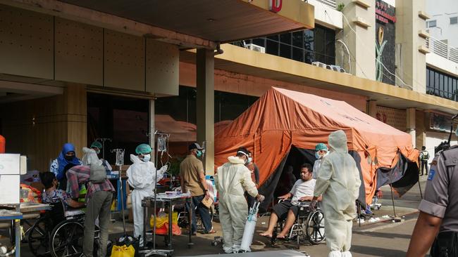 Medical workers treat a patient with Covid-19 in front of the emergency tent outside a Hospital in Bekasi, Jakarta, on July 11. Picture: Anton Raharjo / Anadolu Agency / AFP)