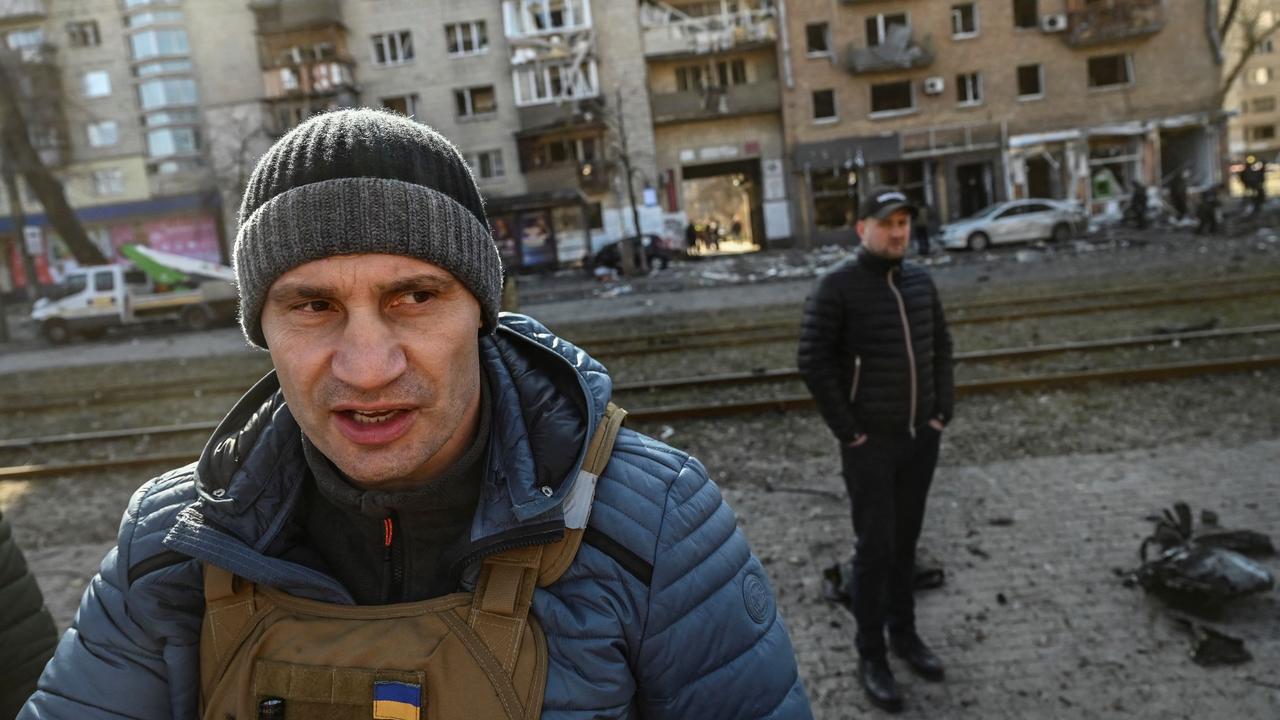 Kyiv's mayor Vitali Klitschko (C) walks in front of a destroyed apartment building, in Kyiv. Picture: Aris Messinis / AFP