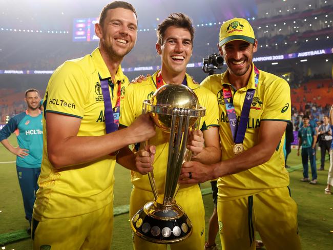 Mitchell Starc (R), alongside Josh Hazlewood (L) and Pat Cummins after winning the World Cup last year. Picture: Getty