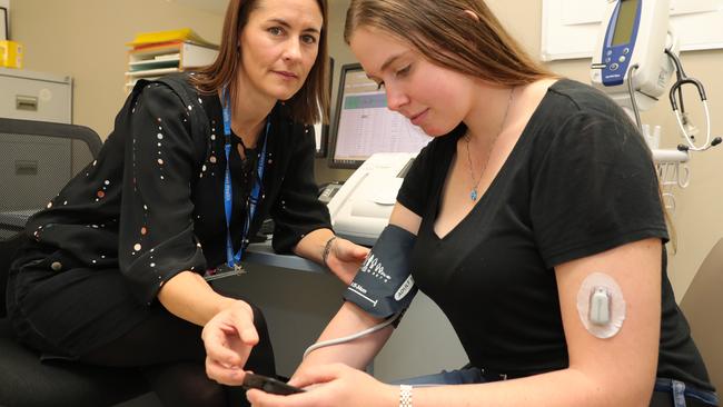 Diabetes Educator Kate Townsley checking on the health of 20 year old Diabetes clinic patient Grace Mitchel from Tallebudgera. Picture Glenn Hampson