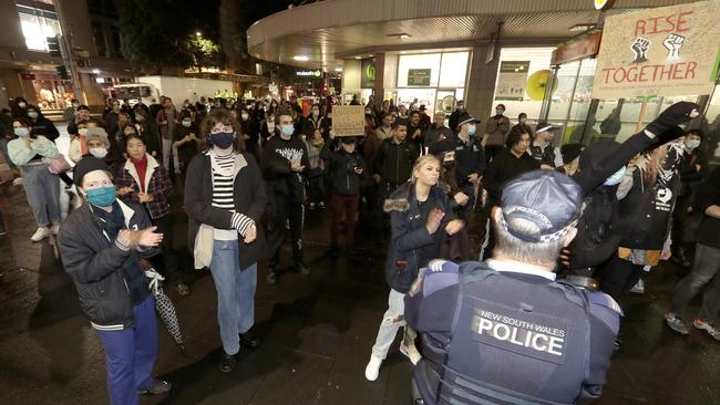 Police watch protesters that gathered in Sydney last night. Picture: AAP