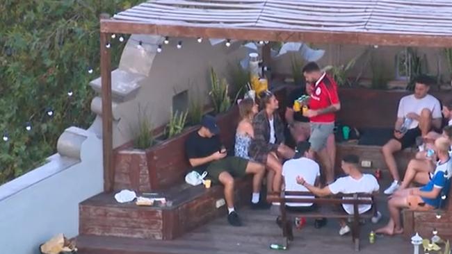 Backpackers in Kings Cross party and ignore social distancing rules before dispersed by police. Picture: 7News