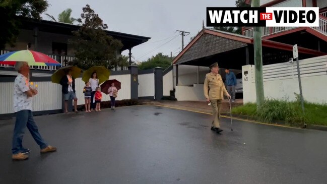 Brisbane vet's moving solo march in front of neighbours