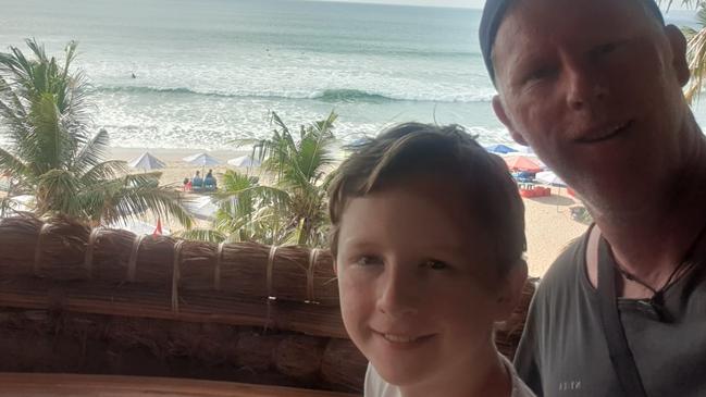 Dominic Buick is stuck in Bali with his family. He is pictured with his son Aran. They have had three flights cancelled. Picture: Supplied