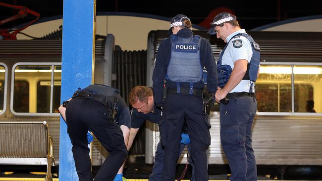 Police investigate a suspicious item after a bomb threat at Indooroopilly station.