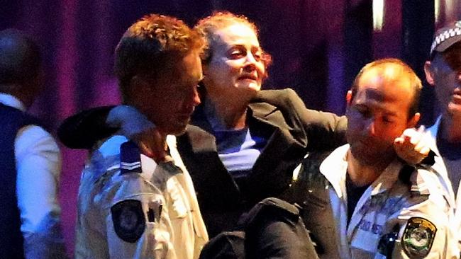 Police carry Marcia Mikhael out of the Lindt Cafe. Picture: Joosep Martinson/Getty Images