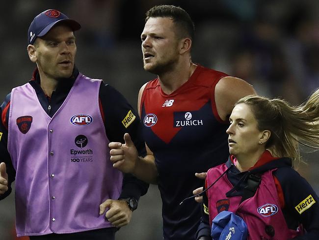 MELBOURNE, AUSTRALIA - MARCH 08: Steven May of the Demons leaves the field with trainers during the AFL Community Series match between the Western Bulldogs and the Melbourne Demons at Marvel Stadium on March 08, 2021 in Melbourne, Australia. (Photo by Daniel Pockett/Getty Images)