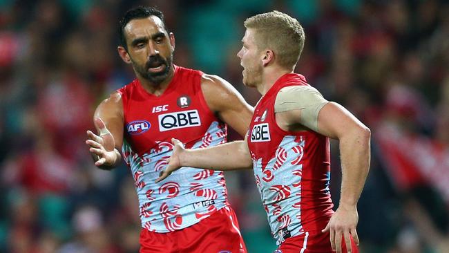 Adam Goodes celebrates a goal with Dan Hannebery.