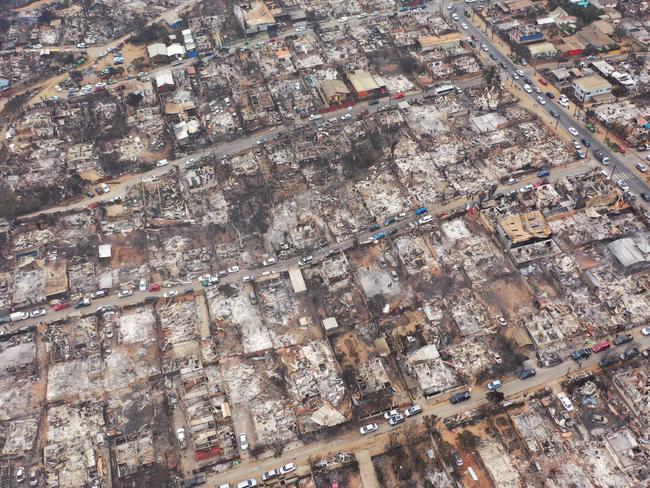 TOPSHOT - Aerial view of burned homes after a forest fire in Quilpue, ViÃ±a del Mar, Chile, taken on February 4, 2024. Chileans Sunday feared a rise in the death toll from wildfires blazing across the South American country that have already killed at least 51 people, leaving bodies in the street and homes gutted. (Photo by RODRIGO ARANGUA / AFP)