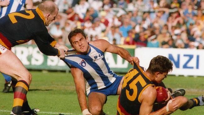 Footballer Andrew Jarman (l) grabs Wayne Schwass (c) who holds Paul Rouvray (r). AFL football - Adelaide Crows vs North Melbourne match at Football Park. Used 12 Jun 1994.